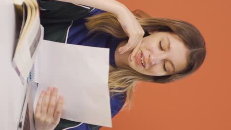 Vertical-video-of-The-young-woman-examining-the-files-approves-the-files-with-her-head.